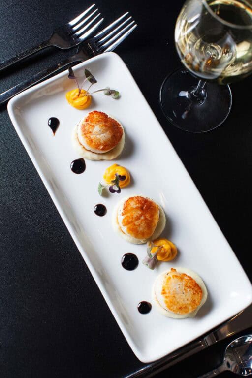 Gourmet scallops with sauce on elegant plate