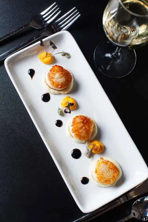 Gourmet scallops with sauce on elegant plate