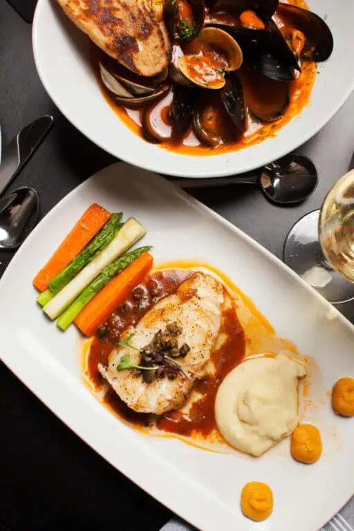 Seafood stew and grilled fish with vegetables.