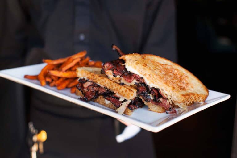 Pastrami sandwich with fries on a plate