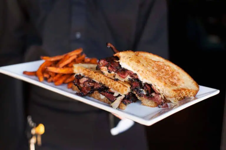 Pastrami sandwich with fries on a plate