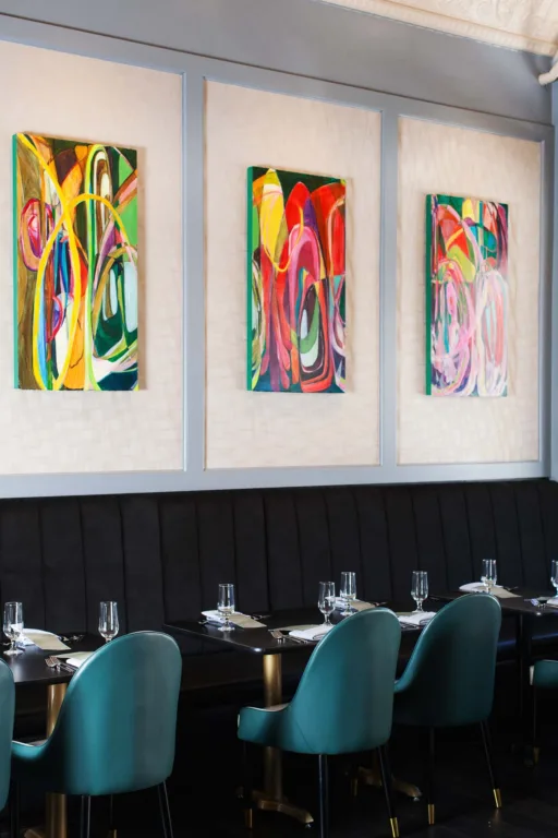 Colorful abstract paintings in modern restaurant interior.